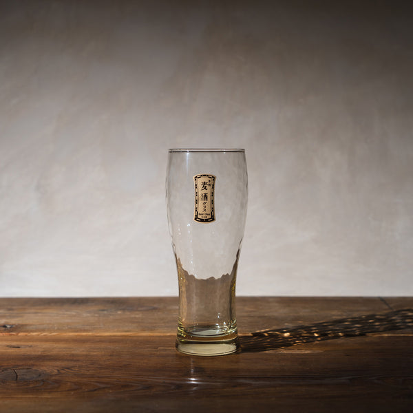 A beer glass on a wooden table