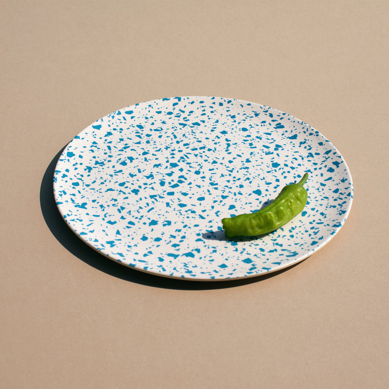 A Xenia Taler 10" lido bamboo plate with a pepper on it