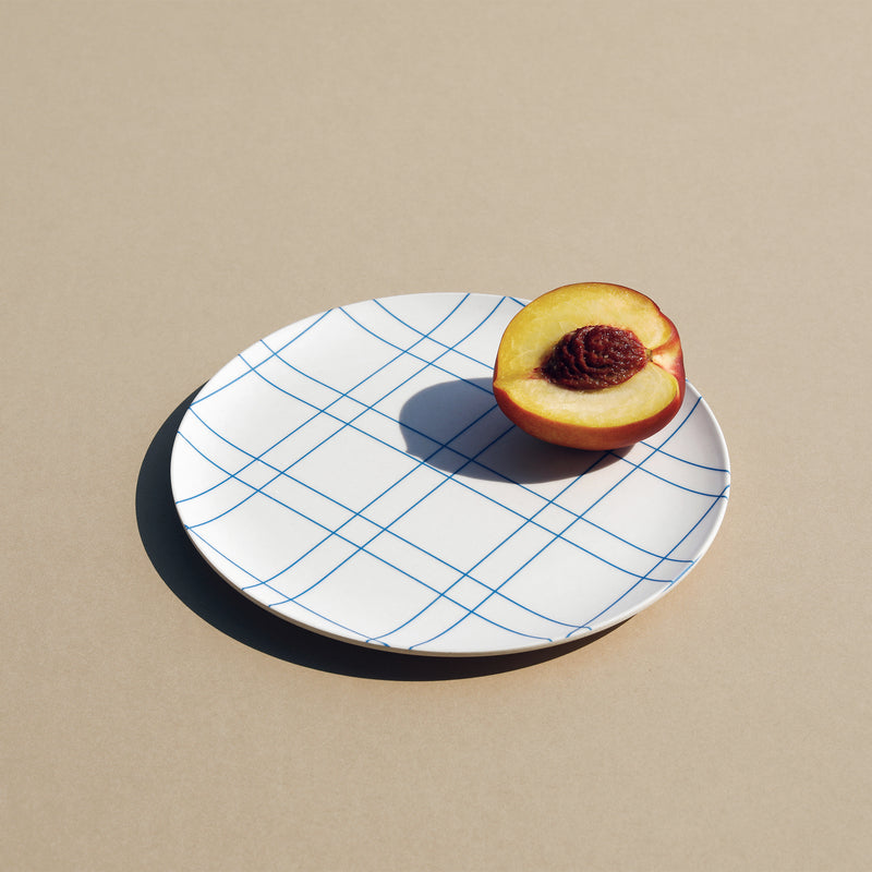A Xenia Taler 8" tucker bamboo plate with a peach on it