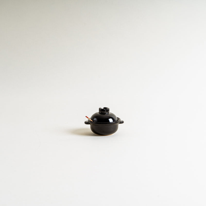 A black mini donabe shape condiment container