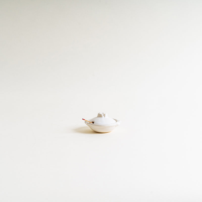 A white mini donabe shape condiment container