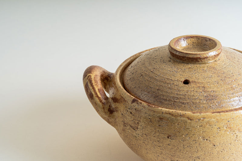Close-up of the Nagatani-en Miso-Shiru Donabe, highlighting its textured surface, lid, and elegant handle.