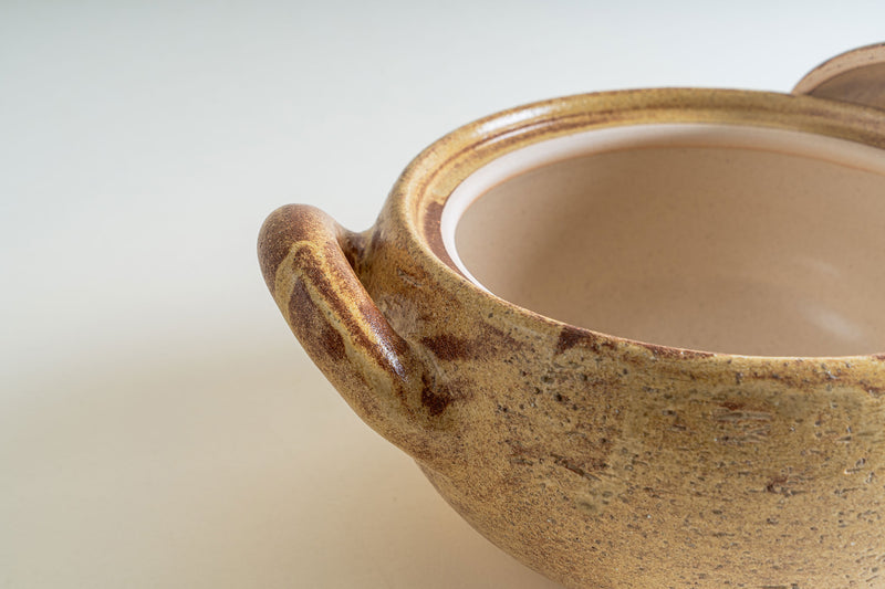 A detailed view of the Nagatani-en Miso-Shiru Donabe, emphasizing the handle's texture and the pot's glazed interior.
