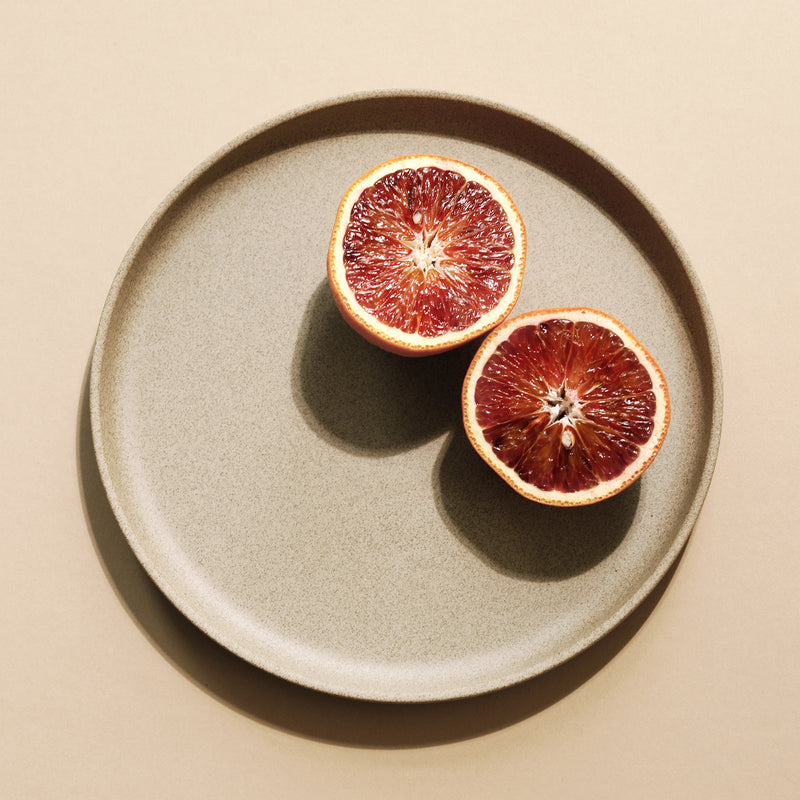 A grapefruit on a 8.6" Hasami Porcelain Plate in Natural - Mogutable