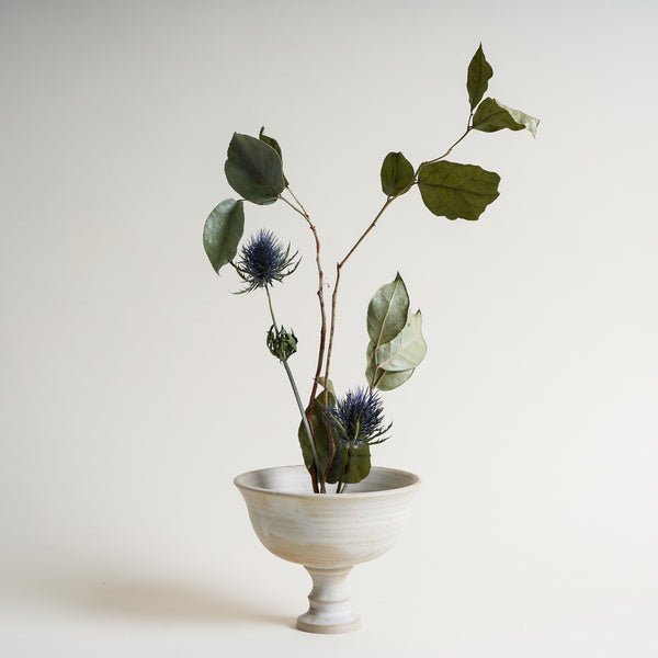 Flower arrangement in a footed ceramic bowl from Sheng Ceramic
